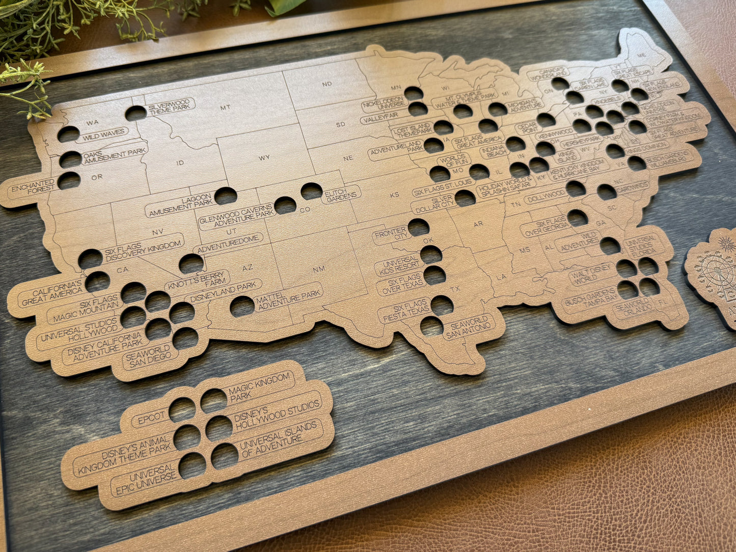 Dark wood map of the United States with cut-out states on a wooden surface
