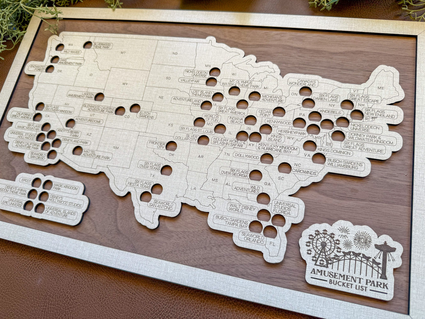 Wooden map of the United States with cut-out holes on a wooden board, featuring 'Amusement Park Bucket List' branding.